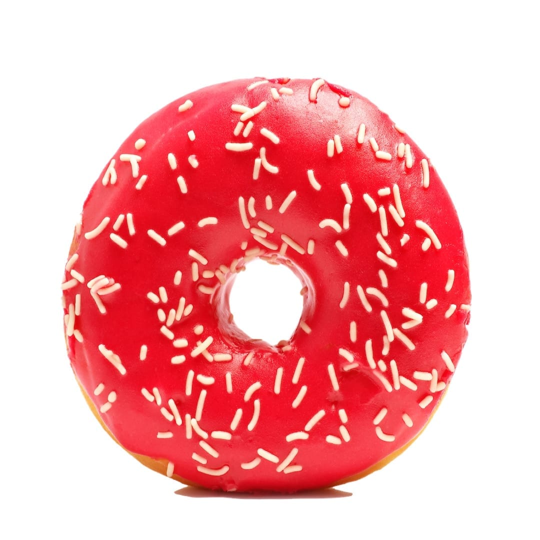 Donut with sprinkles on white background. Pink donut isolated on white background