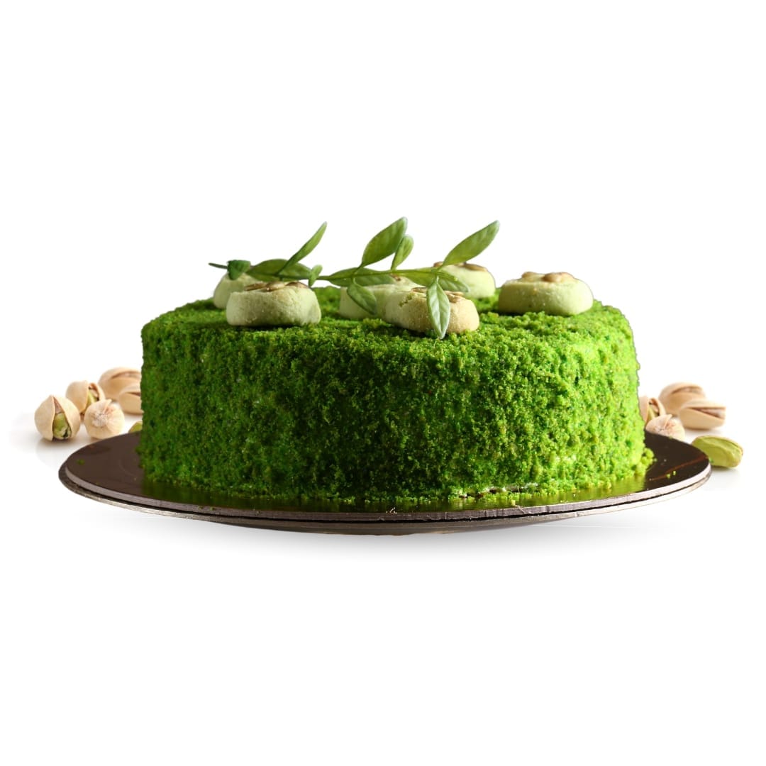 a green cake with nuts on top PISTACHIO ELEGANT VELVET